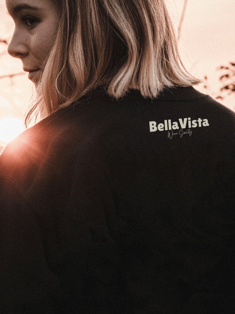 Girl wearing a jumper with Bella Vista Wine Society logo